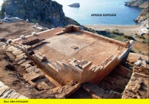Ancient stone ruin on a hillside overlooking a rocky coastline and blue sea, with Greek caption text on the image and a yellow credit bar at the bottom.
