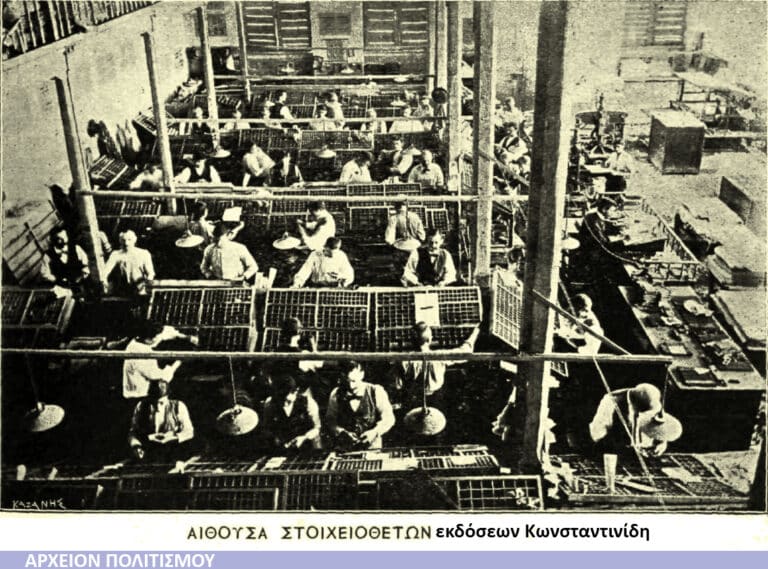 Historical photo of a large textile factory with workers at weaving looms in long rows.