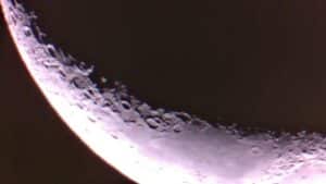 Close-up of the Moon's cratered limb along the terminator, illuminated by sunlight at the edge of a crescent.