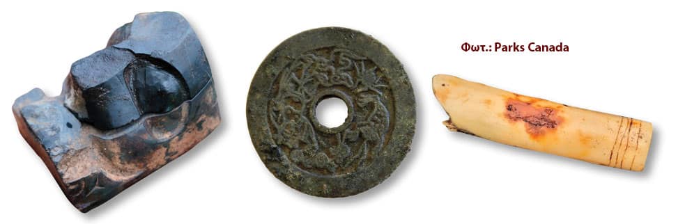 Three ancient artifacts: a dark chipped stone tool, a round disk with a central hole, and a carved bone tube with incised lines.